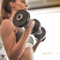 Woman strength training with dumbbells